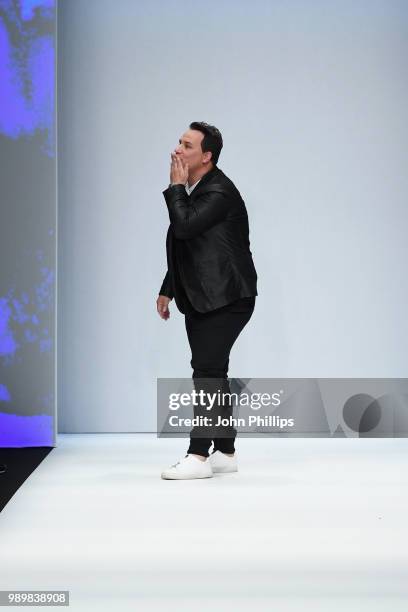 Designer Guido Maria Kretschmer acknowledges the applause of the audience after his show during the Berlin Fashion Week Spring/Summer 2019 at ewerk...