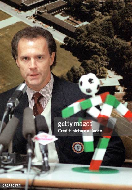 German team manager Franz Beckenbauer shows the Italian 1990 FIFA World Cup Mascot "Ciao" at a press conference in Cologne's Muengersdorfer stadium...
