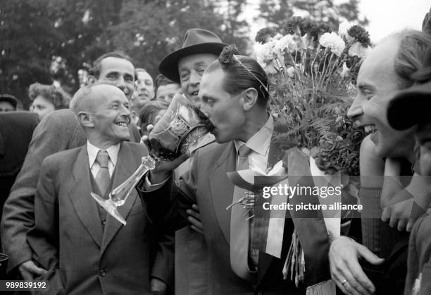 Taking a big sip from an old Club trophy: Welcoming international football player, the striker Max Morlock in Nuremberg on July 7th 1954. He is...