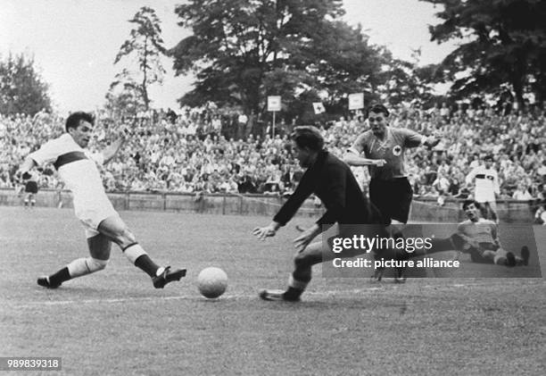 Turkish striker Ertan Mustafa beats German goalkeeper Toni Turek who is running towards him, German defender Karl Mai and teammate Fritz Laband lying...