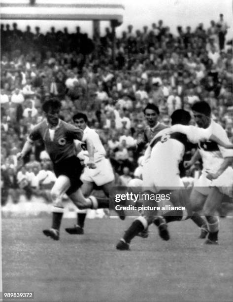 Turkey's Feridun Ismail , Izak Rober and Kucuk Lefter try to defend the German attack from striker Fritz Walter and runner Horst Eckel . Germany wins...
