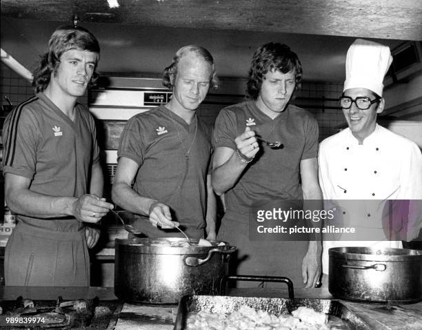 Dutch international football players Johnny Rep, Rudd Geels and Arie Haan check out the kitchen at training camp near Hiltrup on July 26th. The Dutch...