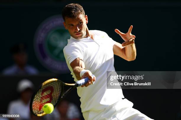 Grigor Dimitrov of Bulgaria returns against Stanislas Wawrinka of Switzerland during their Men's Singles first round match on day one of the...