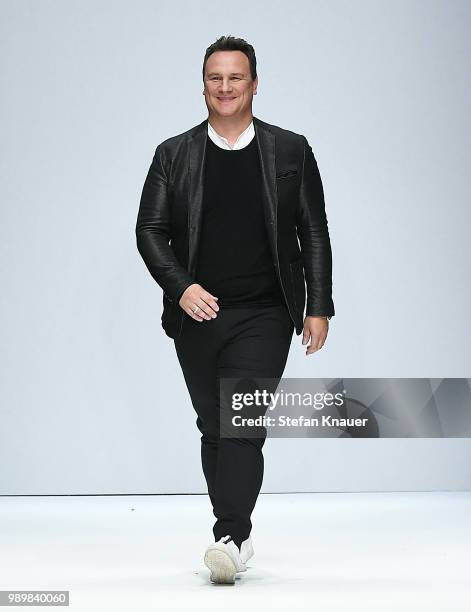 Designer Guido Maria Kretschmer acknowledges the applause of the audience after his show during the Berlin Fashion Week Spring/Summer 2019 at ewerk...