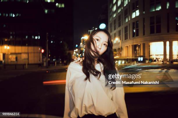 portrait of contemporary young japanese woman at night street - 若い女性 日本人 顔 ストックフォトと画像