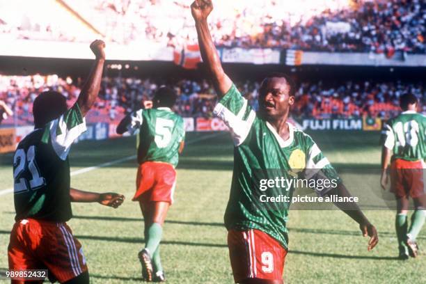 Together with his team mates Cameroon's 38-year-old goalgetter Roger Milla is celebrating one of his two goals against Colombia. Cameroon wins this...
