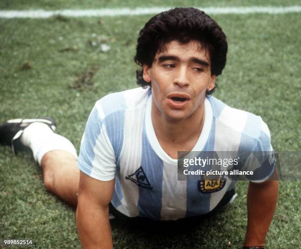 Diego Maradona, Argentina's midfield star, goalgetter and team captain is lying on the field at Mexico City's Olympic Stadium during the 1986 FIFA...