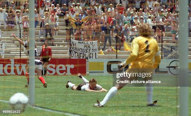 Scottish midfielder Gordon Strachan beats German goalkeeper Harald "Toni" Schumacher, scores the 1:0 and runs off celebrating. German teammate Klaus...