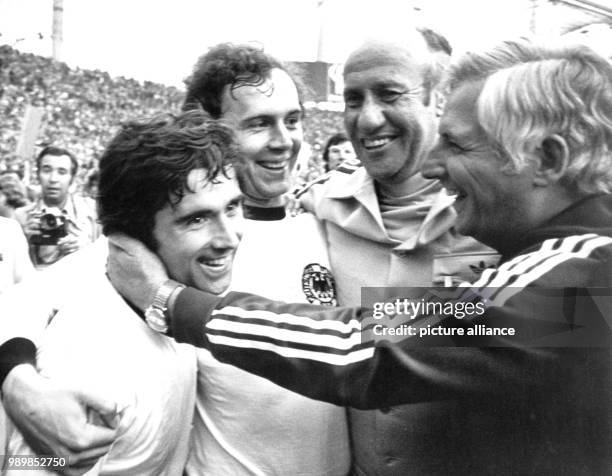 German coach Helmut Schoen, his assistant Jupp Derwall, winning goal scorer Gerd Mueller and team captain Franz Beckenbauer are celebrating their...