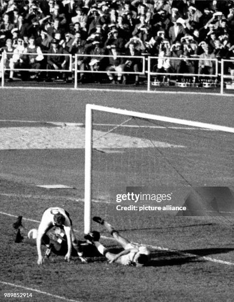 Ground combat for the ball which Brazilian goalkeeper Gilmar has between his legs. English striker Derek Kevan falls over the keeper. Brazilian...