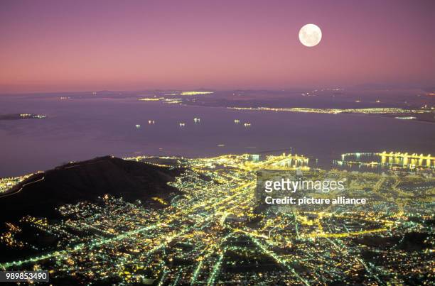 Moon at dusk over Cape town and Table Bay, South Africa, seen from Table Mountain. Undated picture.