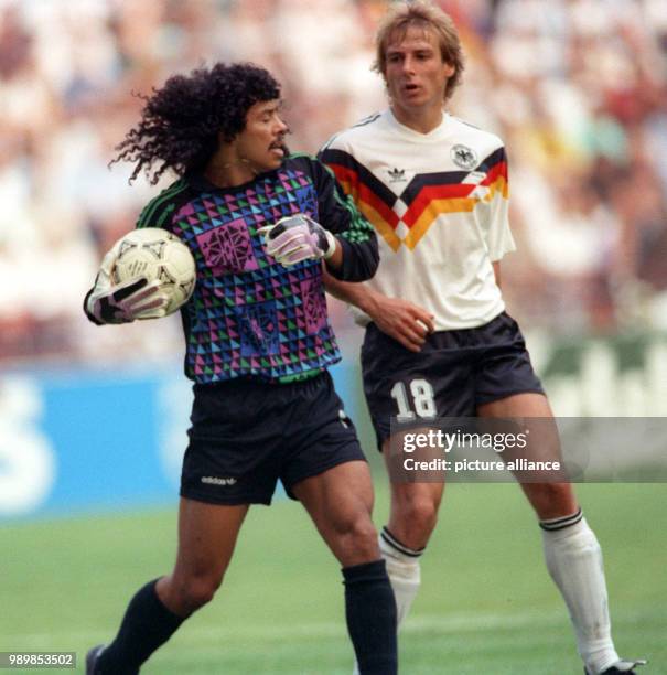 German striker Juergen Klinsmann and Colombian goalkeeper Rene Higuita, who holds on to the ball provocatively long. The match ends with a 1:1 tie in...