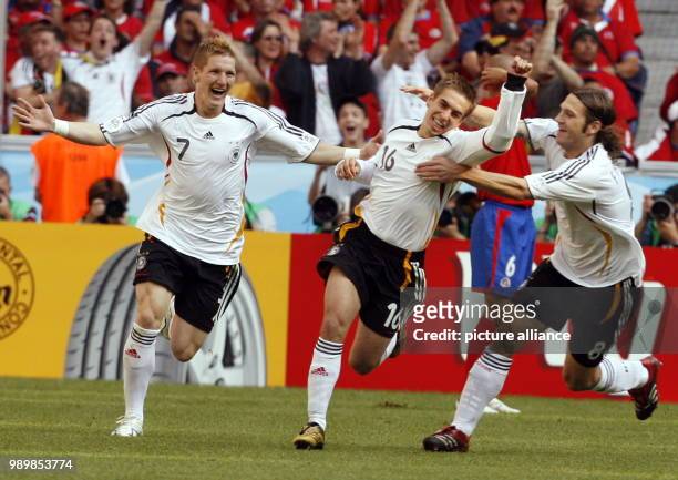German players Bastian Schweinsteiger, Philipp Lahm and Torsten Frings celebrate after the first german goal during opening group A match of 2006...