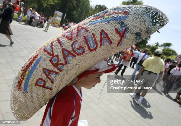 With a giant sombrero on his head a young supporter of Paraguay awaits entering Frankfurt stadium to watch the group B match of 2006 FIFA World Cup...