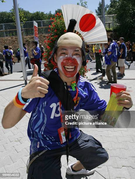 Japanese supporter is proudly presenting his world cup ticket in front of the world cup stadium in Kaiserslautern on Monday, June 12th 2006....