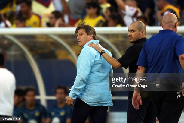 Miguel Herrera, coach of America leaves the field after being expelled during a friendly match between Club America and Santos Laguna at Cotton Bowl...