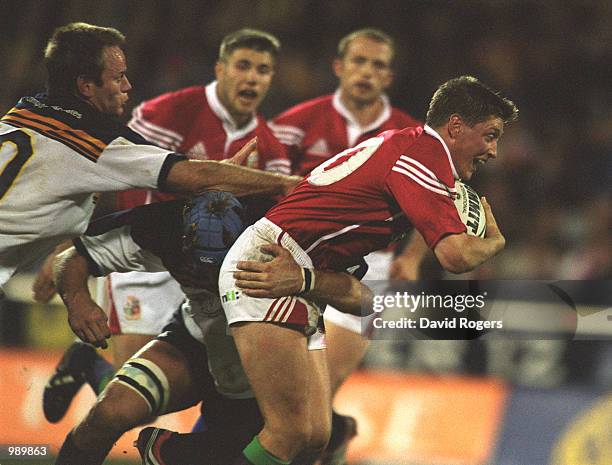 Ronan O''Gara of the British and Irish Lions is tackled by Pat Howard of the ACT Brumbies during the match between the British and Irish Lions and...