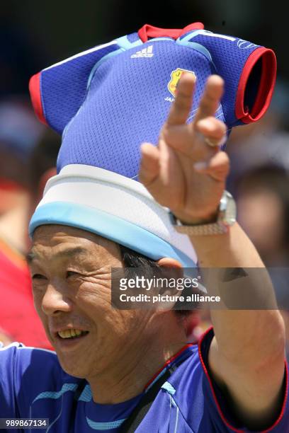 Japanese supporter with unusual headgear is working the crowd at the FIFA world cup stadium in Nuremberg on June 18th 2006. Japan plays a 0:0 against...