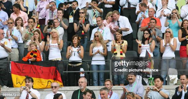 The wives and girlfriends of German soccer players behind the balustrade Conny Lehmann with son behind the german flag, Natalie, girlfriend of...