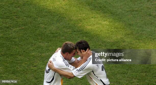 Lukas Podolski celebrates with his teammate Miroslav Klose after scoring the 2-0 lead against Sweden during the 2nd round match of the 2006 FIFA...