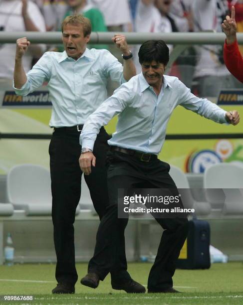 German coach Juergen Klinsmann and his assistant Joachim Loew celebrate during penalty shooting during the quarter final of the 2006 FIFA World Cup...