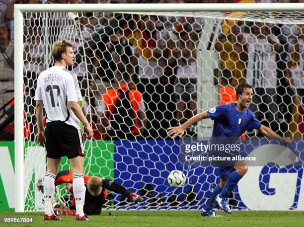 Alberto Gilardino from Italy celebrates next to German Per Mertesacker and Jens Lehmann after Grosso scored the 1-0 lead during extra time of the...