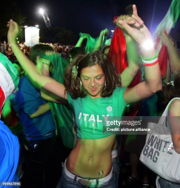 An Italian supporter celebrates after the victory of the Italian national soccer team at the FIFA FAN FEST at the olympic park in Munich, Germany,...