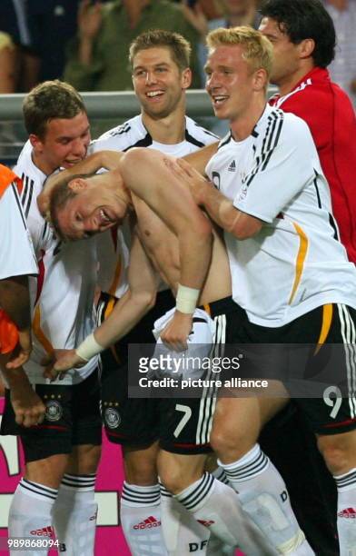 German Lukas Podolski, Thomas Hitzlsperger, Mike Hanke and Michael Ballack celebrate with goal scorer Bastian Schweinsteiger after a goal during the...