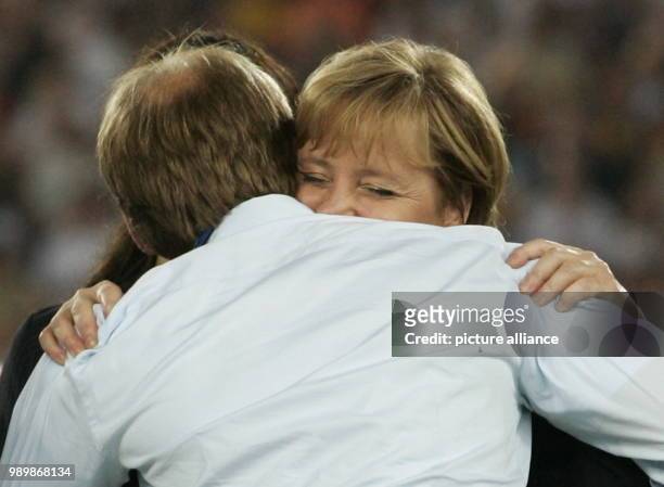 German Chancellor Angela Merkel hugs German team coach Juergen Klinsmann after the 3rd place match of the 2006 FIFA World Cup between Germany and...