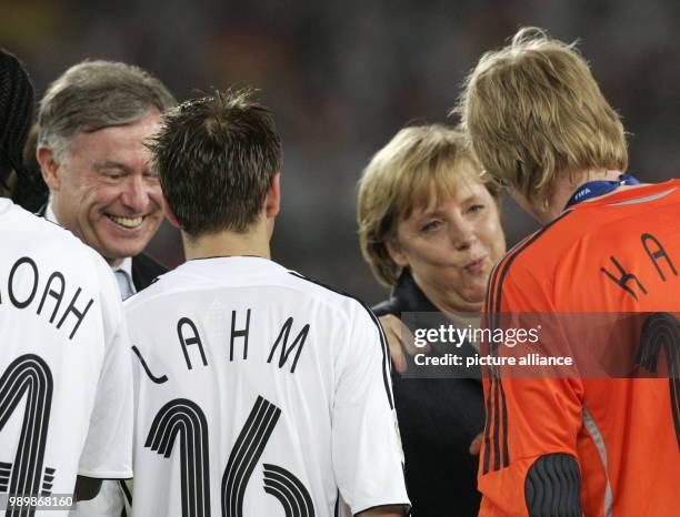 German president Horst Köhler an femal chacellor Angela Merkel congratulate the german team member Philipp Lahm and Oliver Kahn. Germany won the 3rd...