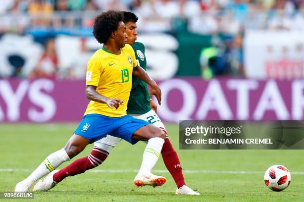 Brazil's forward Willian vies with Mexico's defender Jesus Gallardo during the Russia 2018 World Cup round of 16 football match between Brazil and...