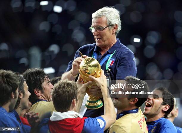 Italian national coach Marcello Lippi celebrates with the World Cup Trophy in his hands at the end of the final of the 2006 FIFA World Cup between...