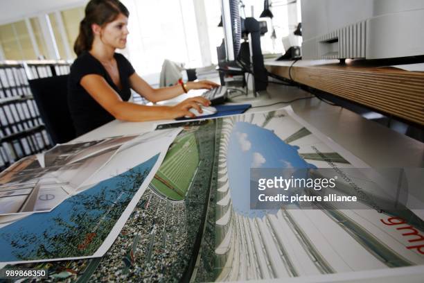 Co-worker of the architect's office Gerkan, Marg und Partner in Berlin is sitting behind large-sized illustrations working on the design for the 2010...