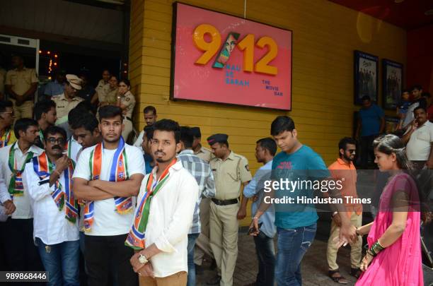 Policemen stand guard outside Balaji Multiplex Kopar Khairane as MNS workers protest against exorbitant prices of the food products served inside the...