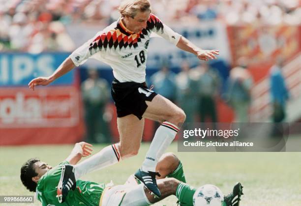 German striker Juergen Klinsmann playing against Bolivian midfielder Jose Milton. Germany wins 1:0 against Bolivia in the opening game of the 1994...