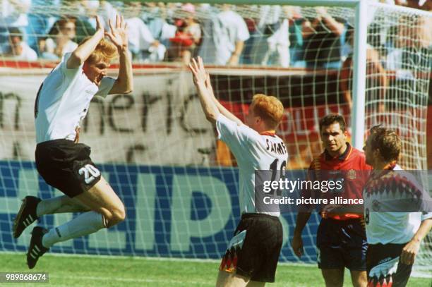 German midfielder Stefan Effenberg is giving a high five to teammate Matthias Sammer after his equalising goal against Spain. The match ends with a...