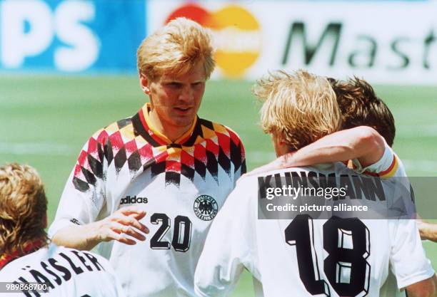 German striker Juergen Klinsmann is celebrating his leading goal against South Korea with teammates Thomas Haessler, Stefan Effenberg and team...