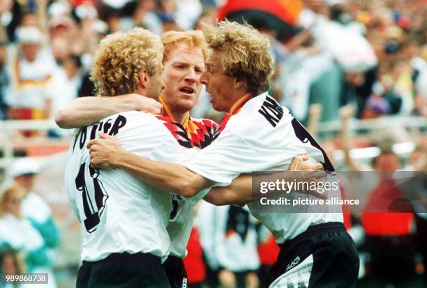 German striker Rudi Voeller is celebrating his 1:0 goal against Belgium with Matthias Sammer and Juergen Klinsmann. Germany wins 3:2.