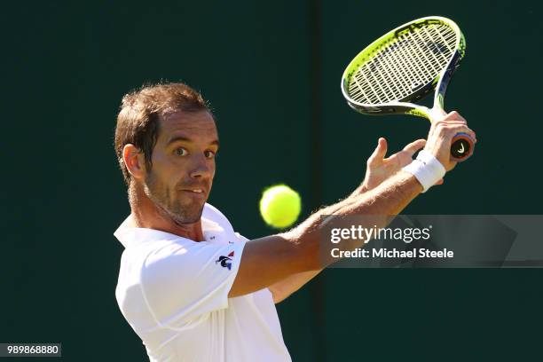 Richard Gasquet of France returns against Gael Monfils of France during their Men's Singles first round match on day one of the Wimbledon Lawn Tennis...