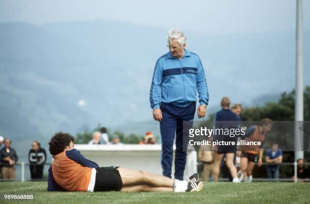 German team coach Jupp Derwall is talking to player Paul Breitner at practice during the World Cup in Spain.