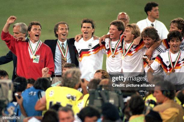 After the 1990 FIFA World Cup final Argentina 1 the German team is celebrating: Holger Osieck, Franz Beckenbauer, Klaus Augenthaler, Stefan Reuter,...