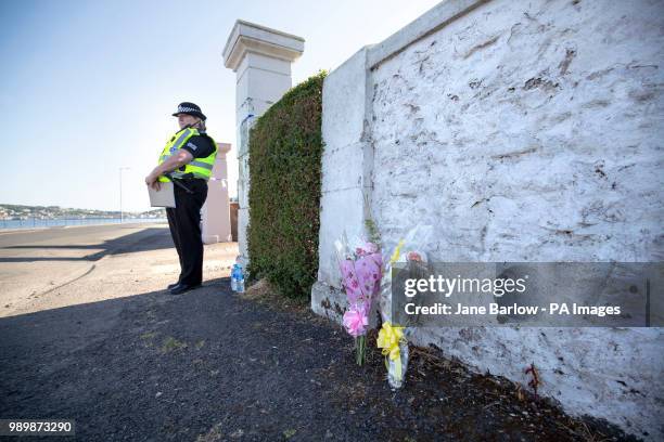Floral tributes near a house on Ardbeg Road on the Isle of Bute in Scotland, after officers found the body of a young girl on the site of the former...