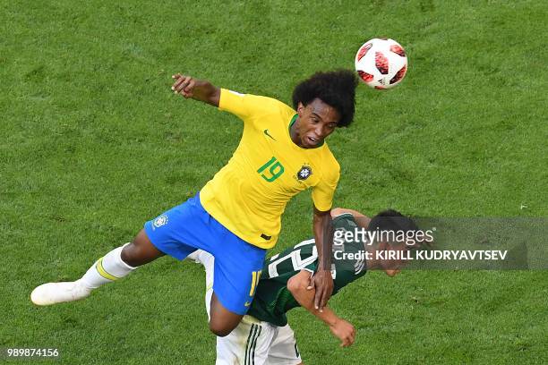 Brazil's forward Willian heads the ball over Mexico's forward Hirving Lozano during the Russia 2018 World Cup round of 16 football match between...