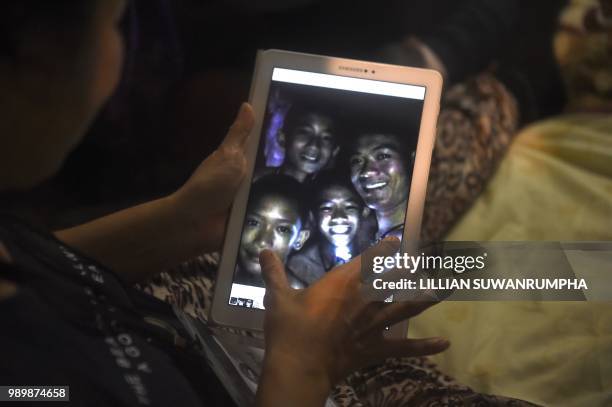 Thanaporn Promthep, mother of one of the 12 missing boys, displays an image believed to have been taken in 2017 of her son Duangpetch Promthep,...