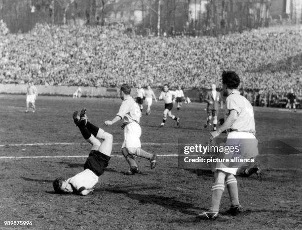 Germany's international player Josef Röhrig falls to the ground. Germany won the World Cup qualifier match 3:1 against Saarland on March 28th 1954 in...