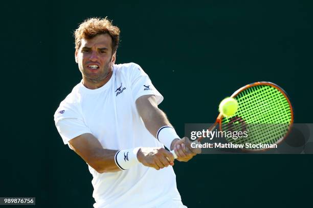 Malek Jaziri of Tunisia returns against Jared Donaldson of the United States on day one of the Wimbledon Lawn Tennis Championships at All England...