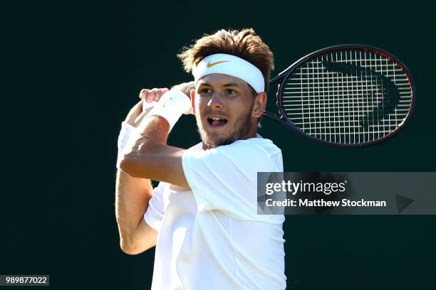 Jared Donaldson of the United States returns against Malek Jaziri of Tunisia on day one of the Wimbledon Lawn Tennis Championships at All England...