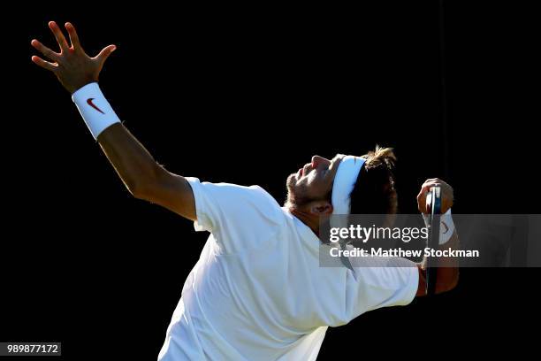 Jared Donaldson of the United States serves against Malek Jaziri of Tunisia on day one of the Wimbledon Lawn Tennis Championships at All England Lawn...