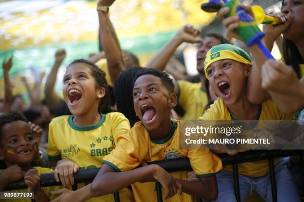 Fans of Brazil celebrate the team's second goal as they watch the World Cup match between Brazil and Mexico on a big screen set on Alzira Brandao...