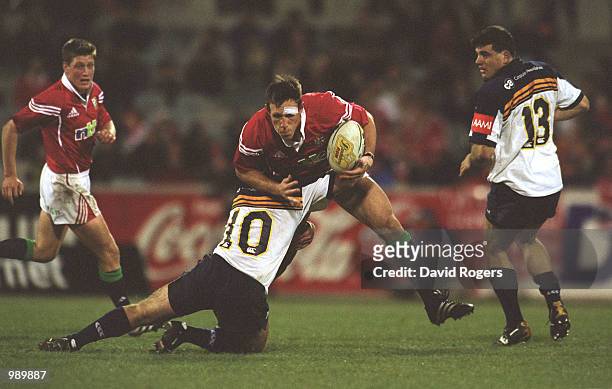 Mark Taylor of the British and Irish Lions is tackled by Pat Howard of the ACT Brumbies during the match between the British and Irish Lions and the...